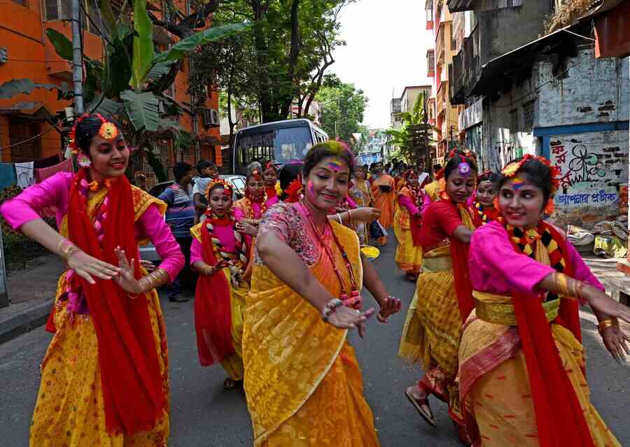 Participants dance at a Doljatra procession in north Kolkata on Friday