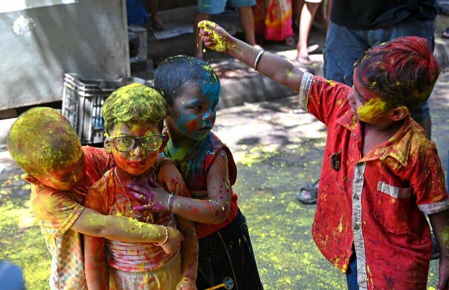 Kids smear 'gulal' or 'aabir' on each other in central Kolkata on Friday