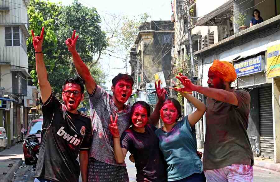 Revellers daubed with colours enjoy Dol in south Kolkata on Friday 