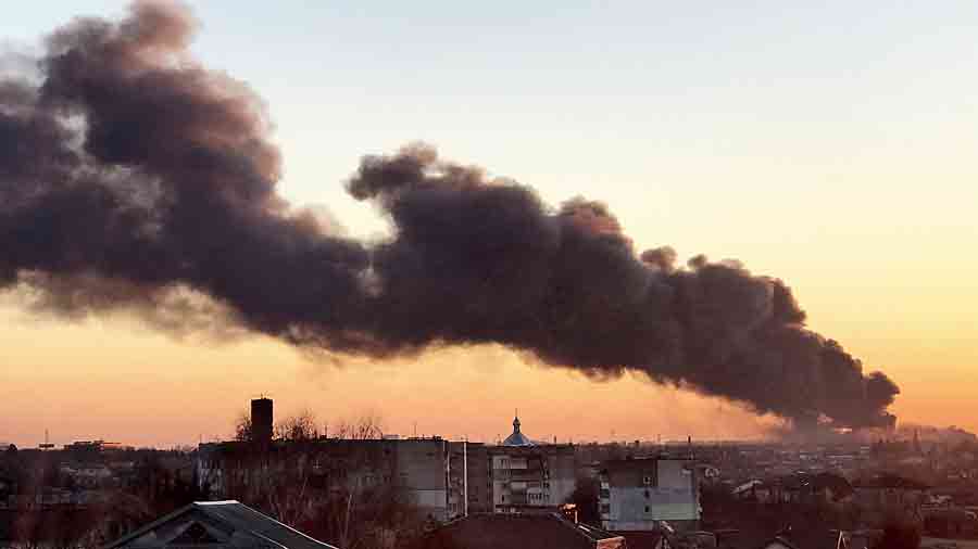 A cloud of smoke rises after an explosion in Lviv on Friday. The mayor of Lviv said missiles struck near the city’s airport early on Friday