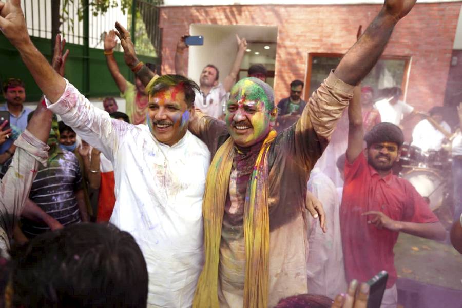 Deputy Chief Minister Manish Sisodia and AAP leader Sanjay Singh play with colours during the celebration of Holi at his residence, in New Delhi.