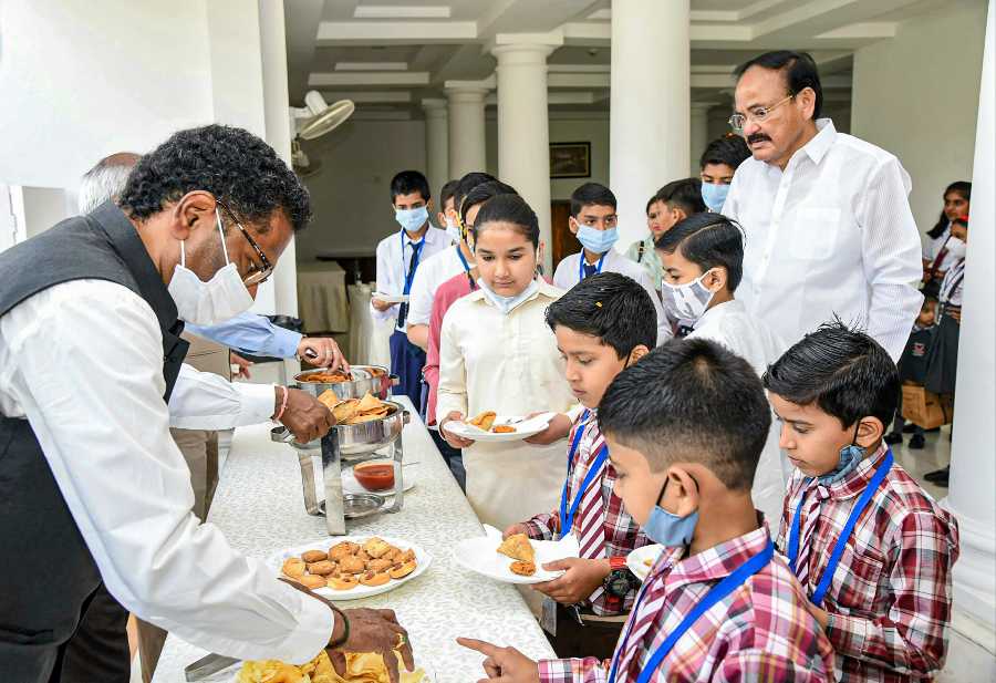 Vice President M. Venkaiah Naidu celebrates Holi with school children, in New Delhi.