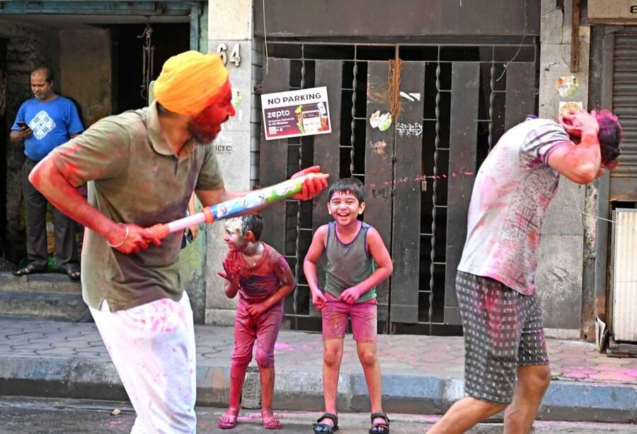 FUN AND FROLIC: Revellers of different age groups daubed with colours enjoy Dol in south Kolkata on Friday, March 18