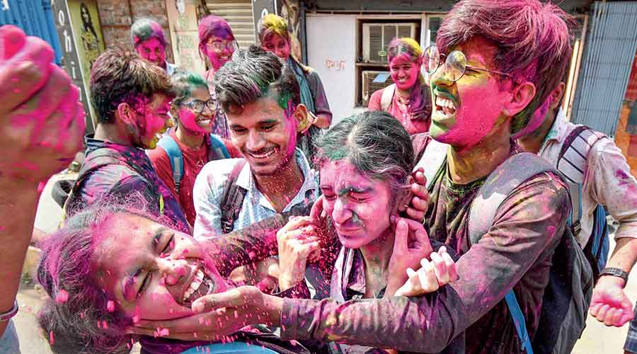 Students play with colours in Patna ahead of  Holi last week.