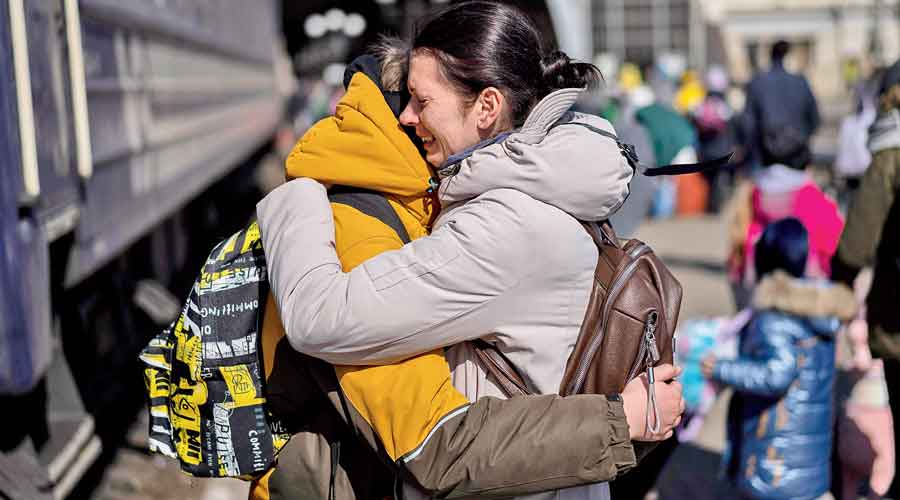 A mother embraces her son after he escaped from the besieged city of Mariupol and arrived at the train station in Lviv, western Ukraine, on Sunday.