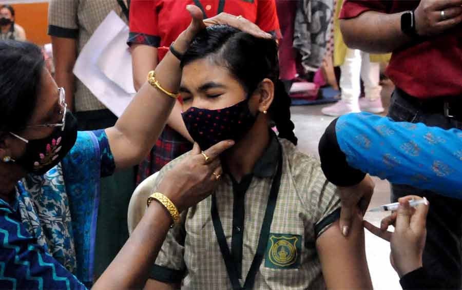 A student gets a vaccination shot against Covid-19 at Saraswati Balika Vidyalaya in north Kolkata on Monday. Kolkata Municipal Corporation has begun administering the Corbevax vaccine to the children between 12 and 14 years from today