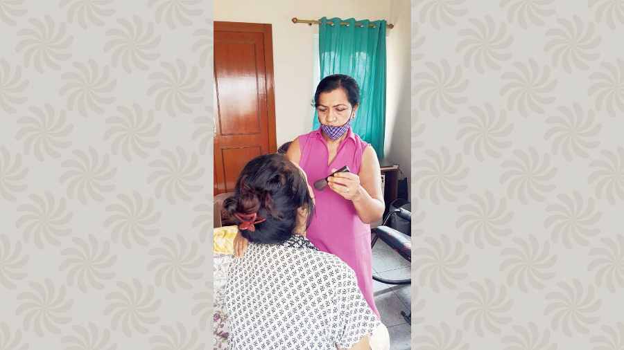 Beautician Puspa Biswas applies make-up on a CK Block resident