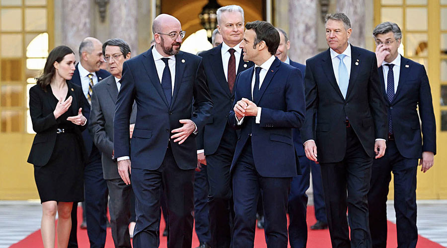 France's President Emmanuel Macron (3rd R) speaks to President of the European Council Charles Michel, followed by EU leaders at the Palace of Versailles, near Paris, on March 10, 2022, prior to the EU leaders summit to discuss the fallout of Russia's invasion in Ukraine.