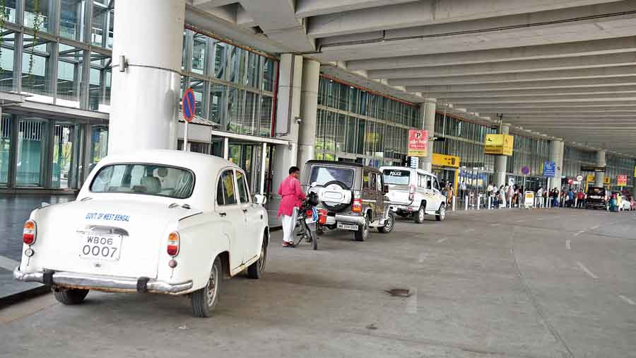 A white Ambassador with a government of West Bengal sticker and a couple of SUVs with police stickers parked in front of the airport on Thursday