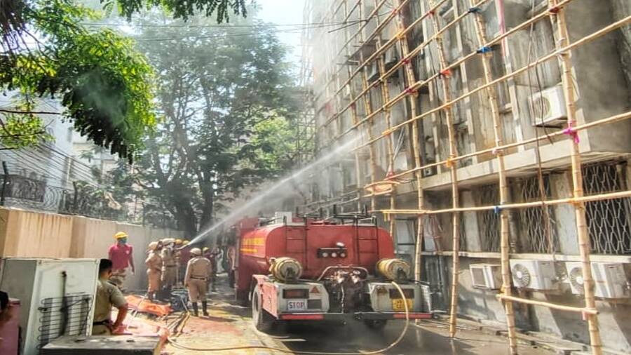 Firefighters at the Indian Institute of Chemical Biology try to douse the fire on Monday morning 