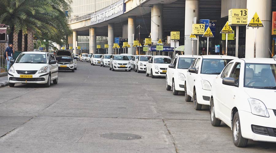 App cabs parked on both sides of the kerb outside the terminal on the arrival level on Monday afternoon. 