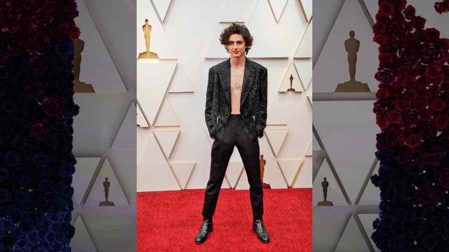 Timothée Chalamet got his fans drooling as he struck a pose in a Louis Vuitton number. The Dune actor also stuck to the prime trend of the night— bling — and went shirtless! Switch on the AC someone!