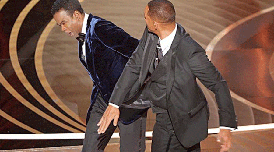 Will Smith strides onstage from his seat and slaps Chris Rock during the 94th Academy Awards.