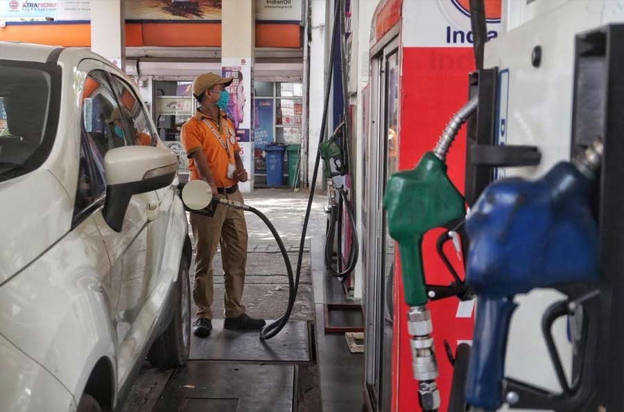 A petrol pump employee at work in south Kolkata on Wednesday. Petrol and diesel prices on Wednesday were hiked again by 84 paise and 80 paise respectively. Fuel prices have increased eight times in the last nine days. Petrol in Kolkata now costs Rs 110.52 and diesel Rs 95.42