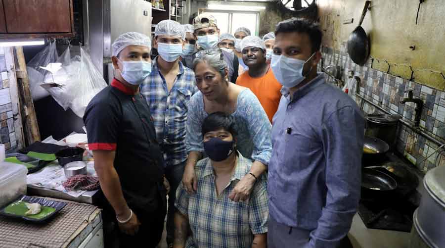 Doma and her daughter Sachiko (seated) with their team in The Blue Poppy Thakali kitchen 