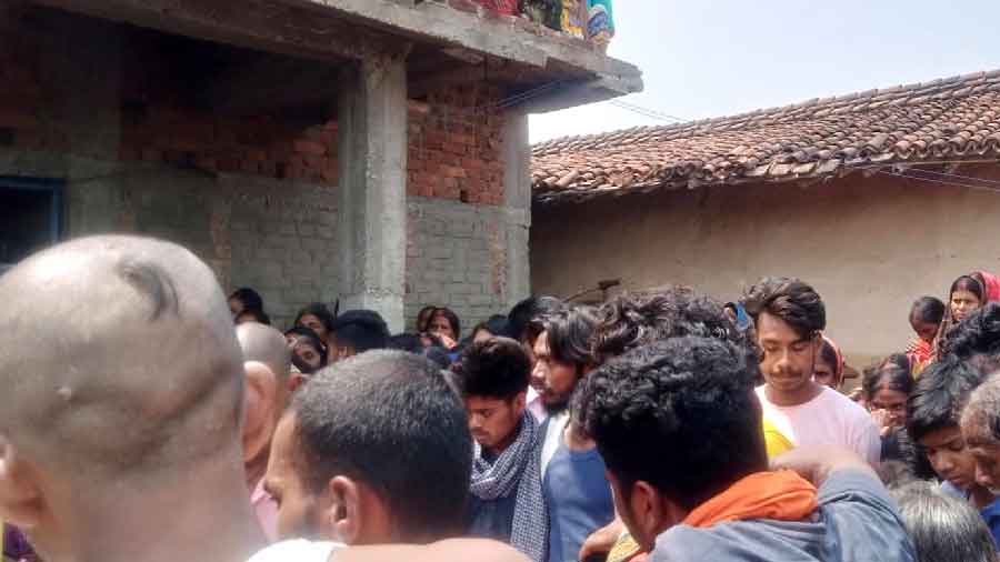 Villagers gather outside the house of Govind Mahto after his dead body reached from Doha at his house in Ghagra village