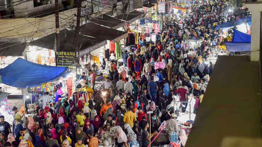 People shop at a market on the last day of the holy month of Ramadan, in Hubballi