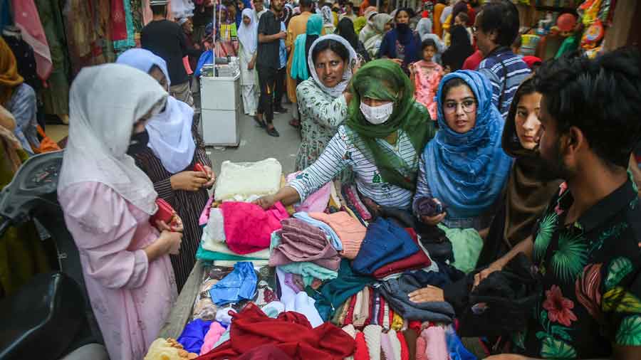 Women shop at a market on the eve of Eid-ul-Fitr, which marks the end of the holy month of Ramadan, in Srinagar