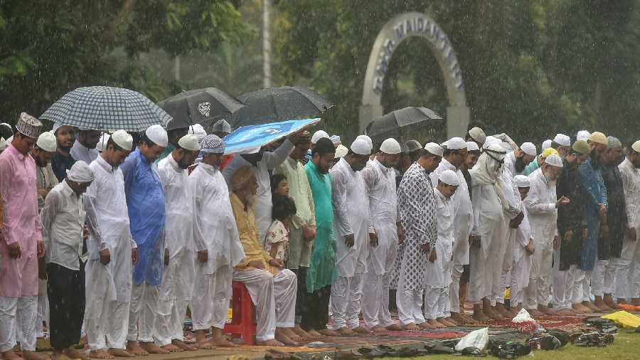 Muslims offer prayers amid rains on the Red Road on the occasion of Eid-ul-Fitr
