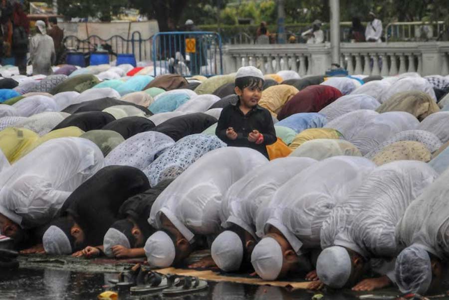 People brave a shower to offer prayers on Tuesday