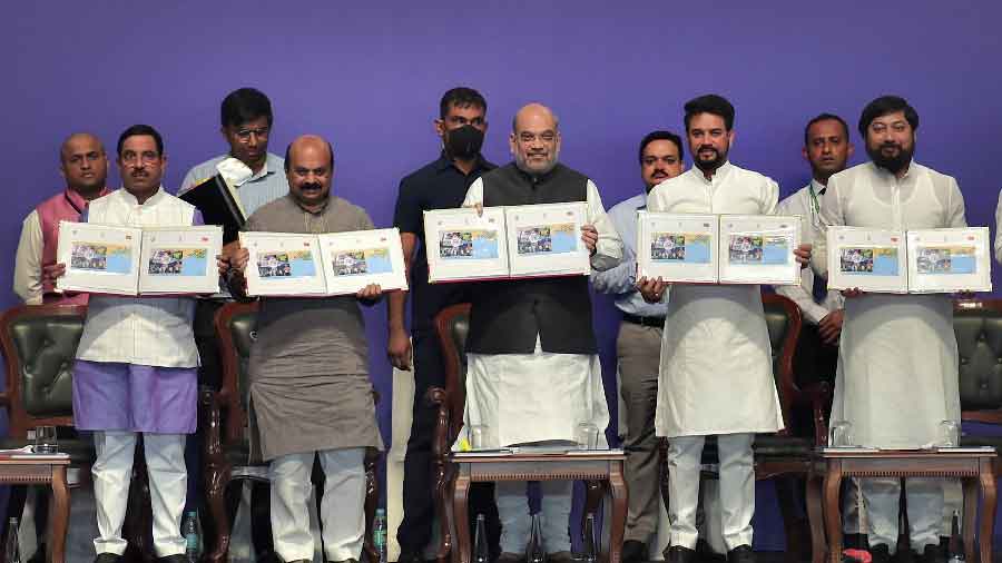Union Home Minister Amit Shah, Karnataka Chief Minister Basavaraj Bommai, Union Parliamentary Affairs Minister Prahald Joshi and Union Sports Minister Anurag Thakur release a booklet during the closing ceremony of the Khelo India University Games 2021, at Kanteerava Stadium in Bangalore