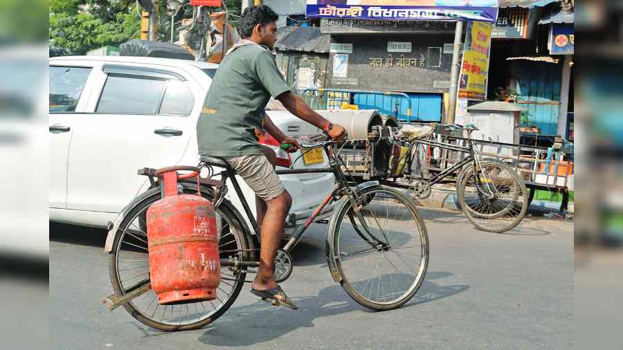 A man carries an LPG cylinder on his cycle  on Wednesday.  