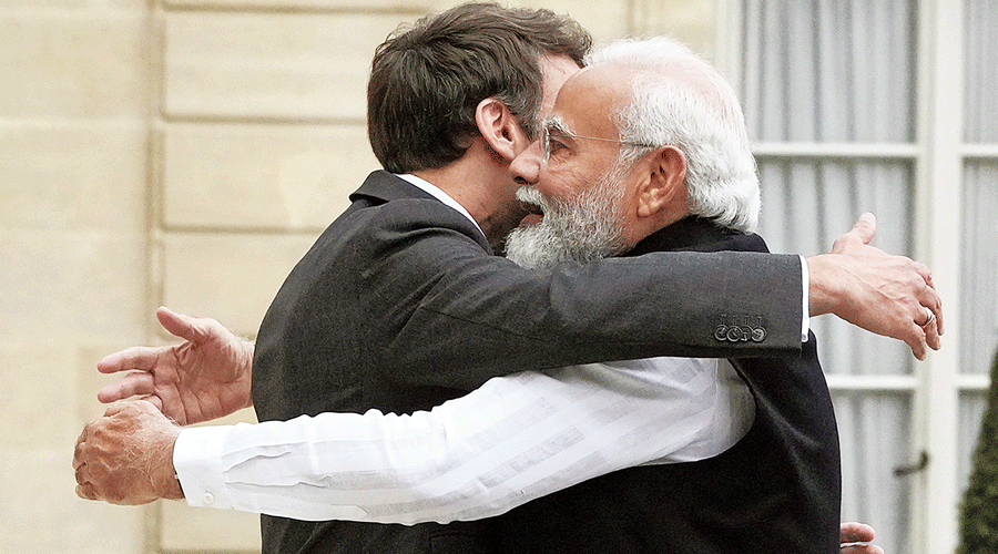 Macron and Modi are locked in a hug at the Elysee palace  in Paris on Wednesday.