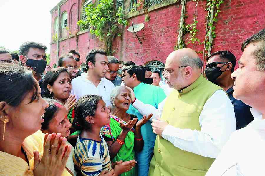 Amit Shah interacts with Arjun Chowrasia’s relatives in Cossipore on Friday.