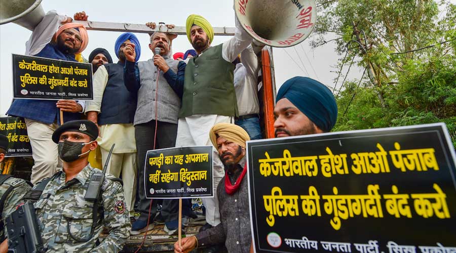 Delhi BJP President Adesh Gupta with party leaders raise slogans during a protest against the arrest of party spokesperson Tajinder Pal Singh Bagga, outside Delhi Chief Minister Arvind Kejriwal’s residence, in New Delhi on Saturday,.