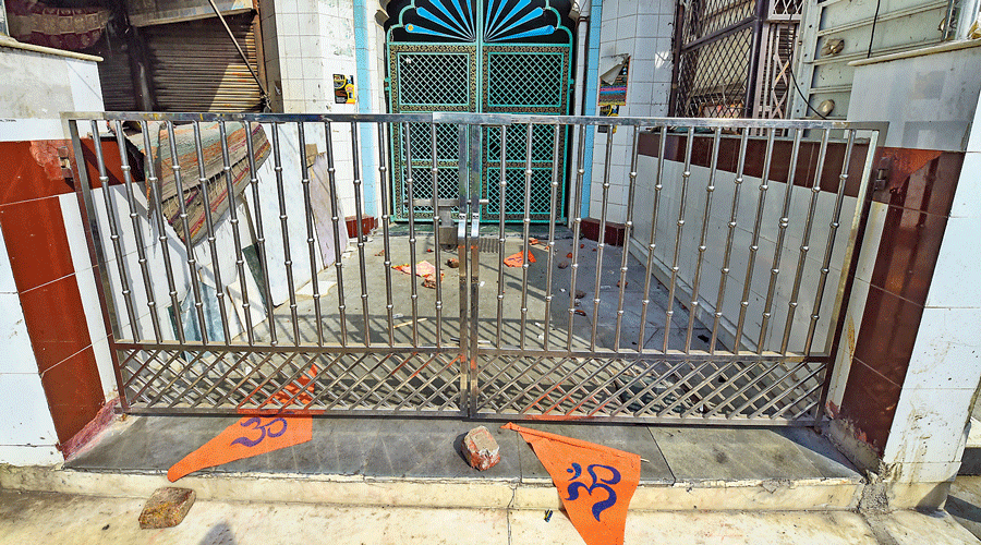 Saffron flags and brickbats lie at the entrance and on the premises of a mosque at Jahangirpuri in New Delhi on April 17.