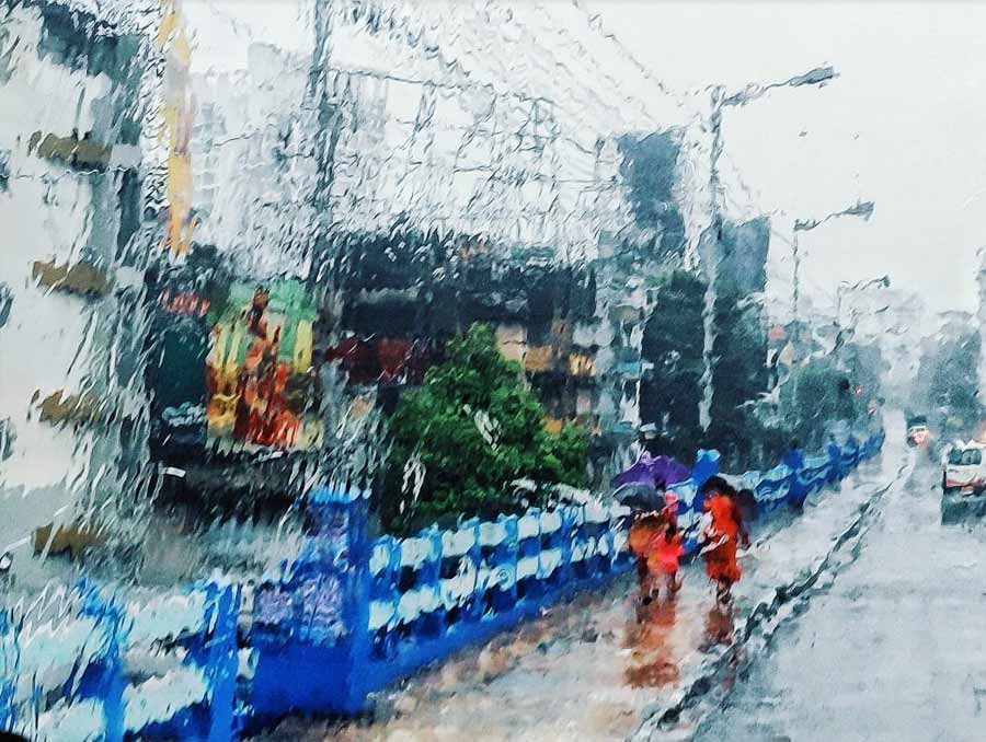 Panchanantala: The unending streams of rain flowing down the windows of cars painted a picture reminiscent of a water colour art.   