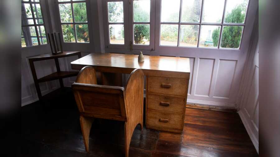 Tagore's workstation with a uniquely-shaped chair designed by him and carved by his son Rathindranath, who had accompanied his father on one occasion