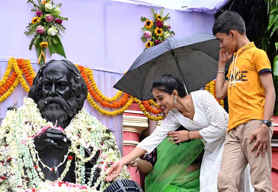 A youth pays a floral tribute to a bust of Rabindranath Tagore in his ancestral home at  Jorasanko