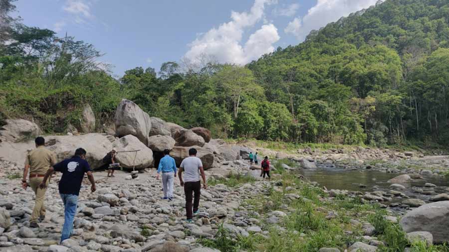 Team members of the Mahseer Conservation Project by Glenburn Tea Estate walk along the banks of river Rangeet on May 8, 2022  
