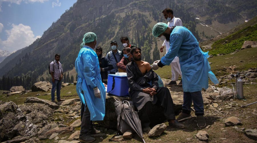 A healthcare worker administers a dose of CoviShield, a coronavirus disease vaccine, to a shepherd during a vaccination drive in Lidderwat, located in India Kashmir's Anantnag district, June 10, 2021. (Sanna Irshad Mattoo) 