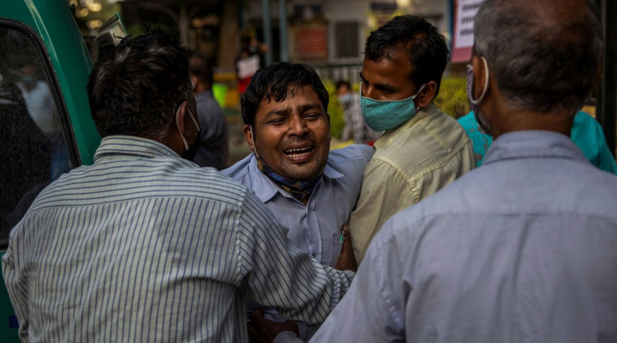 A man grieves as his family member is declared dead outside the coronavirus disease casualty ward at the Guru Teg Bahadur hospital in New Delhi, India, April 23, 2021. (Danish Siddiqui)
