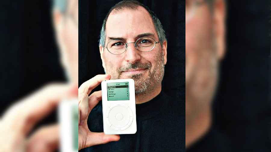Apple CEO Steve Jobs holds the iPod after its launch in Cupertino, California, on October 23, 2001. 