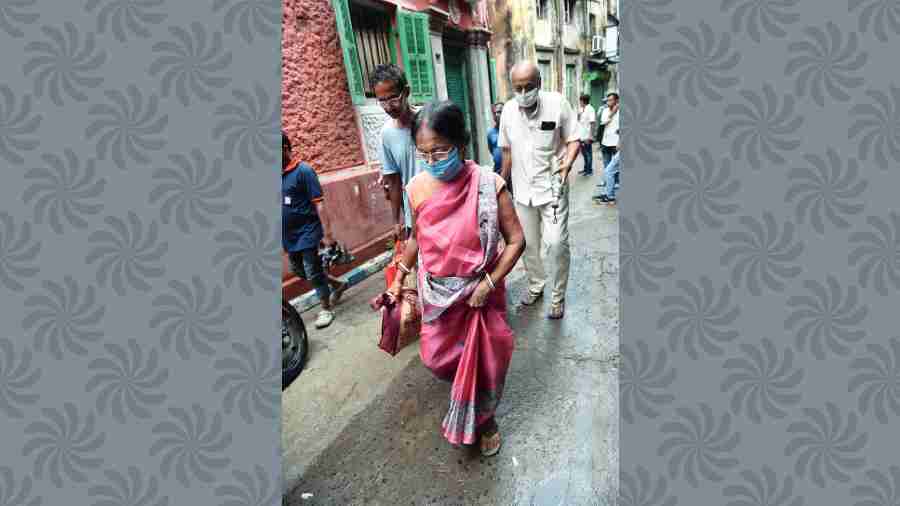 Residents of Durga Pituri Lane move out of their homes on Thursday.  