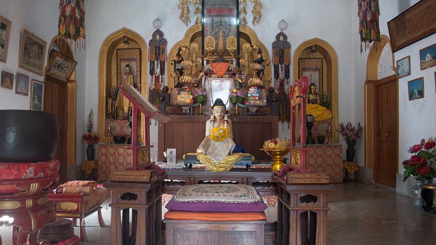 A marble Buddha sits inside the temple 