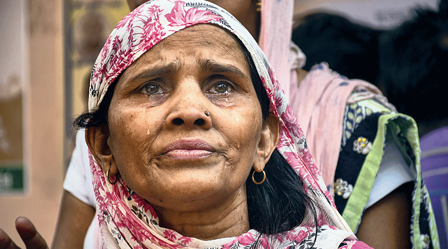 A family member of one of the 29 people missing after the Delhi fire waits outside  Sanjay Gandhi Memorial Hospital on Saturday.