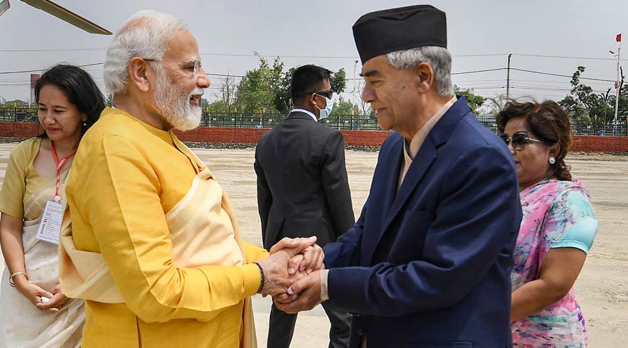 Prime Minister Narendra Modi being greeted by Nepal PM Sher Bahadur Deuba as he arrives in Lumbini