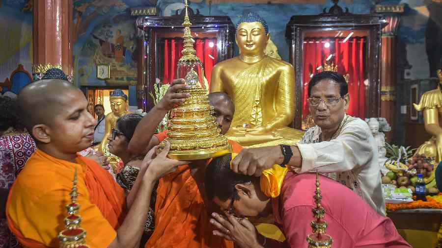 Devotee seeks blessings from monks at Mahabodhi Society, in Calcutta