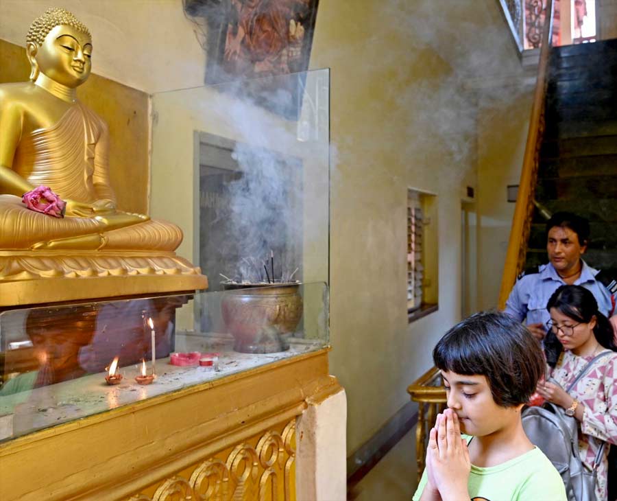 A girl prays in front of an idol of Lord Buddha on the occasion of Buddha Jayanti on Monday. 