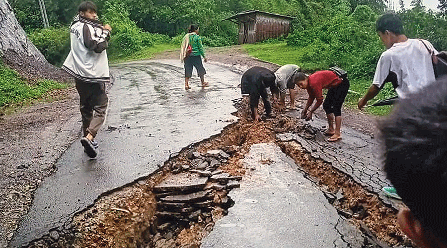 A damaged road following heavy rainfall in Dima Hasao district of Assam on Tuesday.