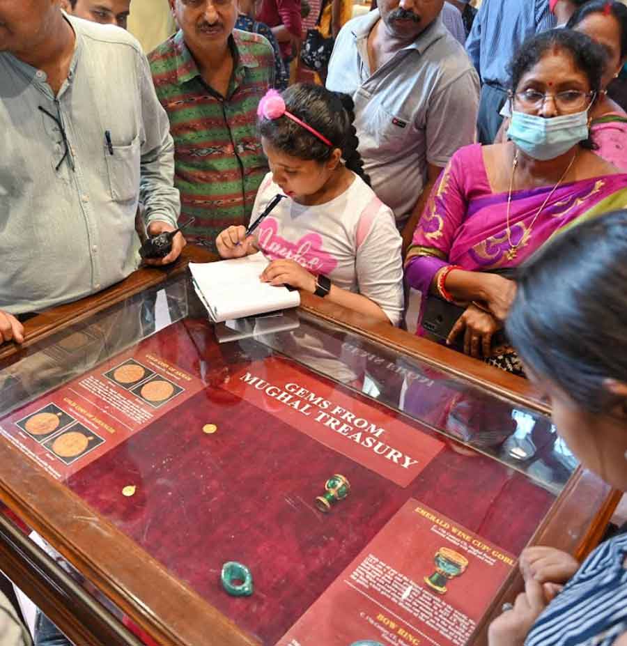 A child takes notes while going through exhibits at The Indian Museum on International Museum Day on Wednesday 