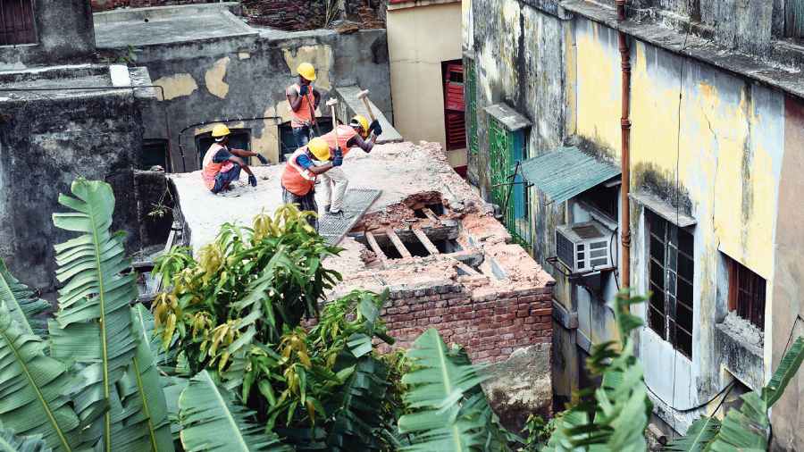 A building in Durga Pituri Lane being demolished on Wednesday. 
