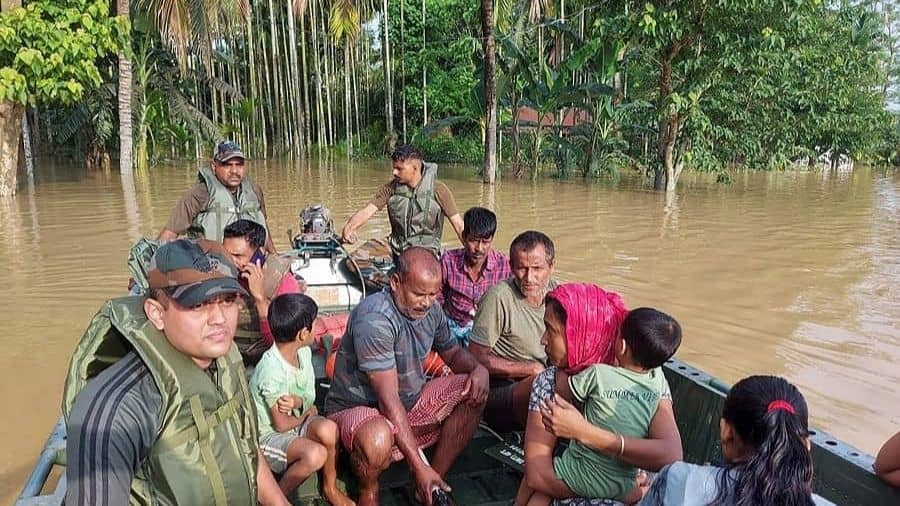Blazing Sword Division of Gajraj Corps of the Indian Army evacuates people during flood relief operations after heavy rainfall in Hojai district