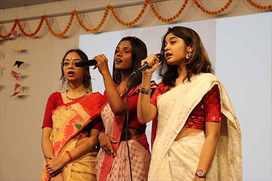 Draped in saris, students sang Amaro porano jaha chay, Tumi robe nirobe and Amar bela je jaye. 