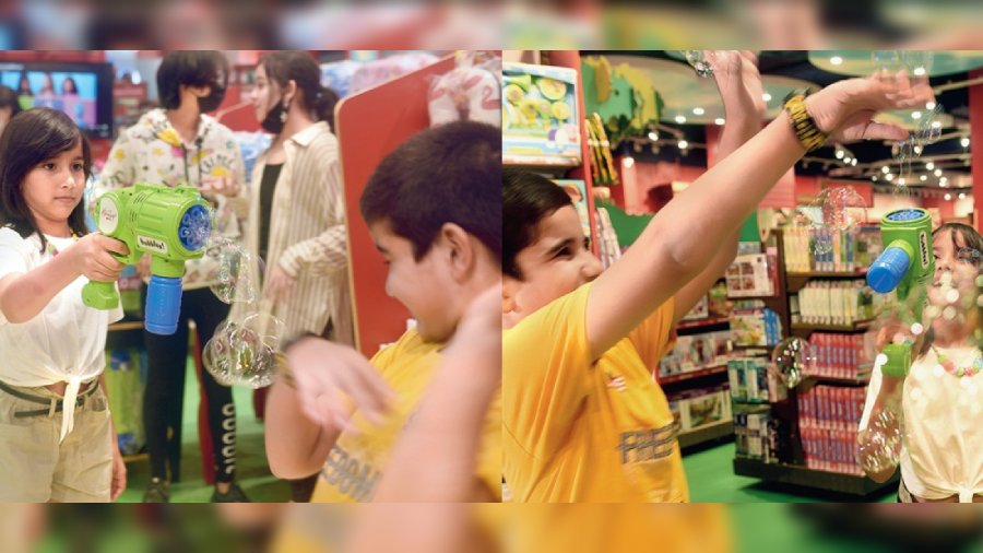 Brother-sister duo Kaira and Vivaan play around with a Hamleys Bubble Gun, joined by the others.