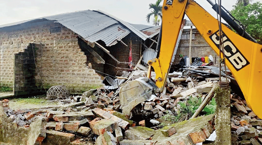 An earthmover during the eviction drive in Nagaon in Assam on Sunday.